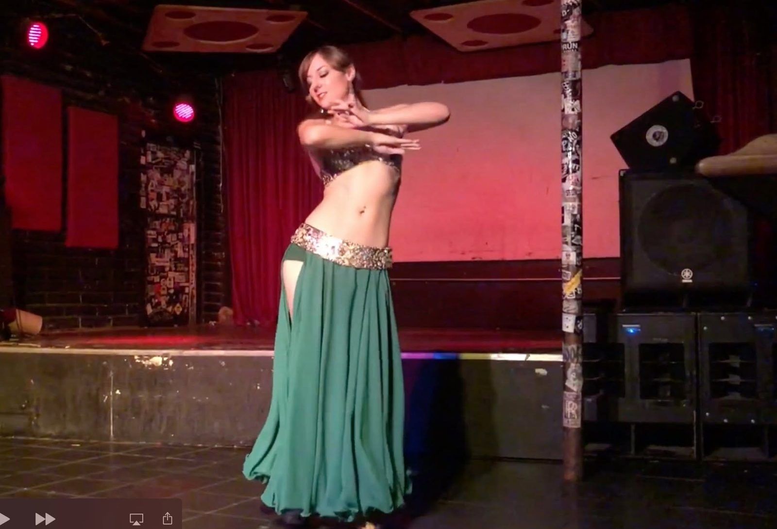 Amalphia Sylva in a green skirt on stage